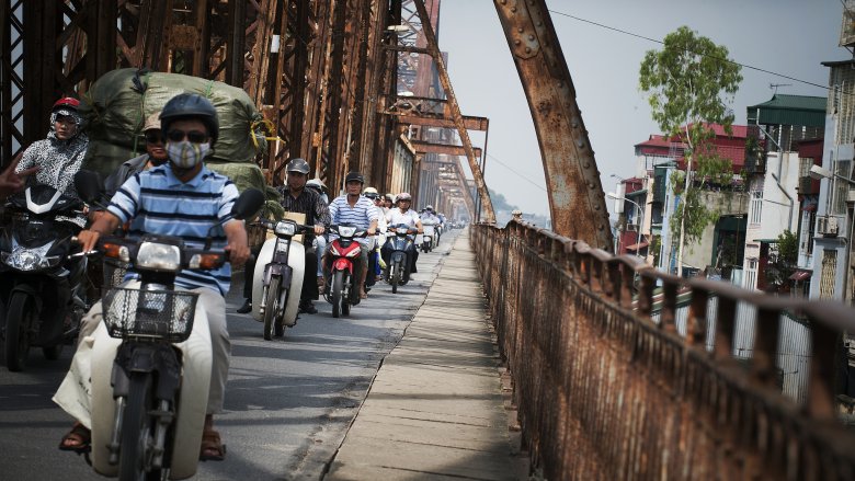 Motorbikes crossing Long Bien Bridge on the Red River in Hanoi, Viet Nam